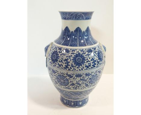 A large Chinese blue and white porcelain vase with stylised floral design and ring handles. Qianlong mark. h29cm 