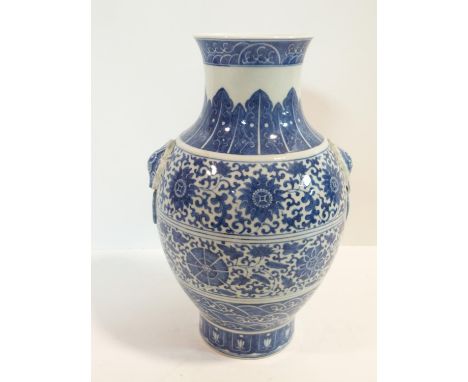 A large Chinese blue and white porcelain vase with stylised floral design and ring handles. Qianlong mark. h29cm 