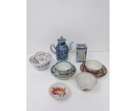 A collection of Qing dynasty Chinese porcelain items. Including a blue and white tea pot with cloud decoration, a small bowl 