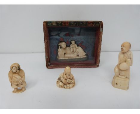 Four Japanese and Chinese carved ivory netsuke, one in a glass fronted silk lined case and one with a revolving face. H10.5x9