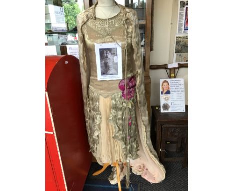 An early 1920s mid length wedding dress with it's matching cape, the dress is typical, it belonged to the vendors grandmother