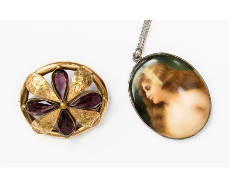 A Victorian pinchbeck and purple glass brooch, engraved petal details tear drop stones with oval surround, approx 40mm x 38mm