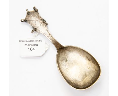 A Claus Anderson 830 silver caddy spoon, with mechanised decoration marks and two coiled silver wire rings through perforated