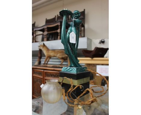 A dark green painted spelter Art Deco lamp base of a standing female nude, raised upon a square chamfered black slate and ony