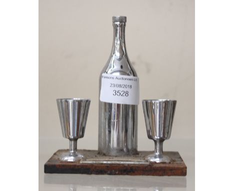 An Art Deco chrome novelty cigarette lighter in the form of a wine bottle and goblets, on stand 