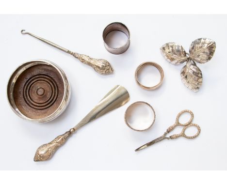 Silver drinks coaster, London 1991, three silver napkin rings, approx 1.7 ozt, a silver trinket dish in the form of three lea