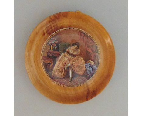 A Staffordshire Prattware Polychrome  Pot Lid mounted in a light wooden frame  'Lady Tying Her Shoe'Circa 1880Size  7cm diamC