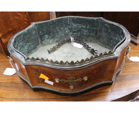 A French, late 19th Century shaped oval gilt metal mounted jardiniere the sides veneered with walnut and wood panels one side