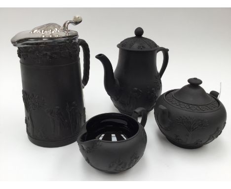 A Wedgwood black basalt  four piece coffee set, water jug has EPNS cover, impress mark to the base "Wedgwood" Date 1930Impres