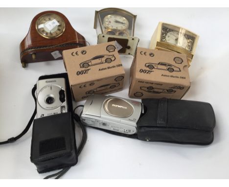 A group of three vintage clocks to include a Goldbuhl, circa 1950s birdsong clock, Schatz carriage clock and a miniature wood