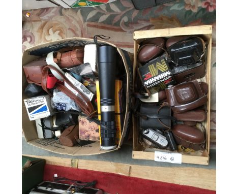 Four boxes containing a large quantity of camera accessories, empty carry cases and small SLR cameras and an Optomax 500mm 1.