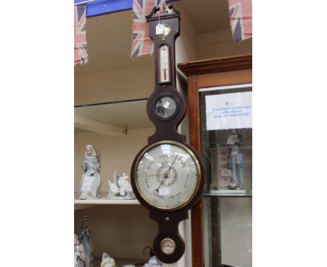 A mahogany wheel barometer, including thermometer, spirit level 