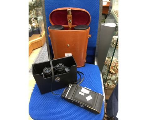 Binoculars in leather case and 1950s camera