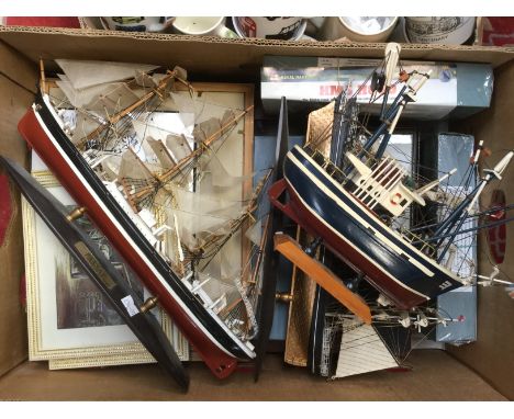 A box of transport related mugs, ceramic money boxes etc, and a box of framed pictures and model ships
