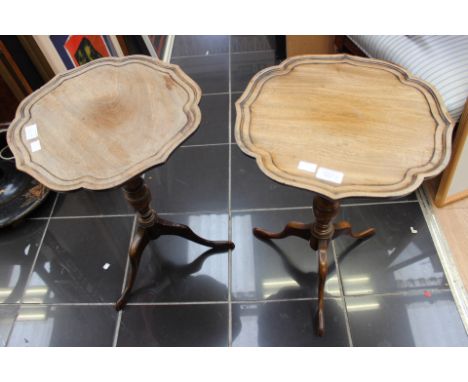 A pair of Waring and Gillow mahogany pedestal wine tables, raised on tripod bases, (2)