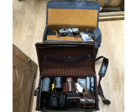 Petri-flex SLR camera and lenses in carry case; together with a further case containing cameras including Voightlander 