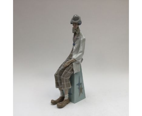 A large Lladro figure of a sad clown with accordion, approx 18 inches high, blue factory mark