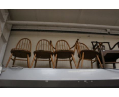 A set of four Ercol light beech and elm seated stick back chairs, comprising two carver chairs and two side chairs, together 