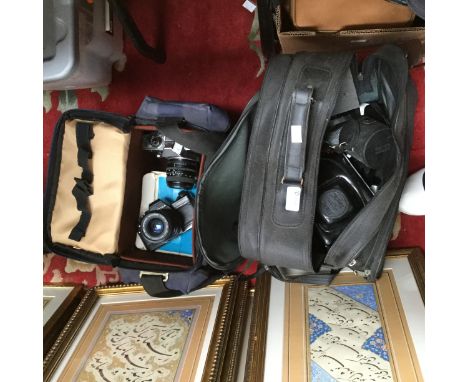 A pair of camera cases with contents of Canon, Praktica, Zenit, bodies and various lenses 