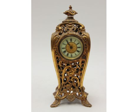 A solid pierced gilt brass cased mantle clock, produced by the British United Clock Company, Birmingham patented mechanical w
