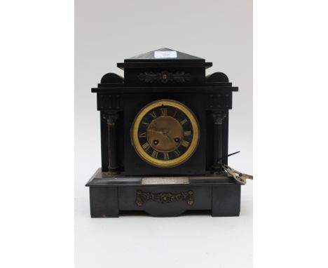 A black slate, 8 day mantle clock, Roman numerals on black and guilded dial, silver presentation plaque, dated 1903, key