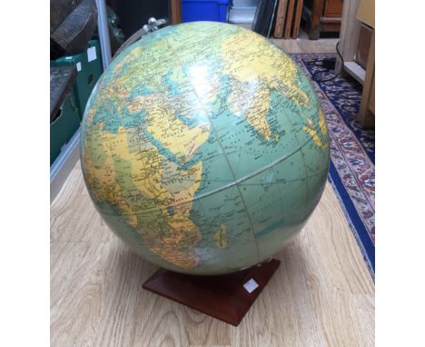A circa 1950s globe on teak base