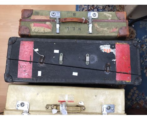 A cream suitcase with travel stickers 1950s with metal fastenings together with a black and red 1930/40s trunk with WMW motif