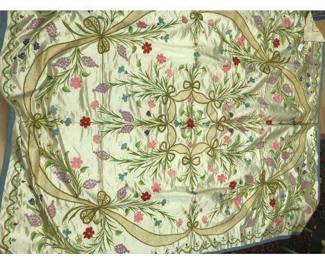 An early 20th century satin double bed spread/throw, the cream ground with embroidered flora with bowls and garlands, approx 