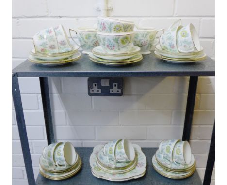 A Minton 'Vanessa' patterned teaset comprising ten cups, fifteen saucers, fifteen side plates, two cake plates, two milk jugs