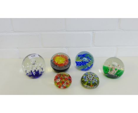 A collection of six paperweights to include three Caithness with pattern names 'Impulse', 'Oration' and 'Sun Flare' (6) 