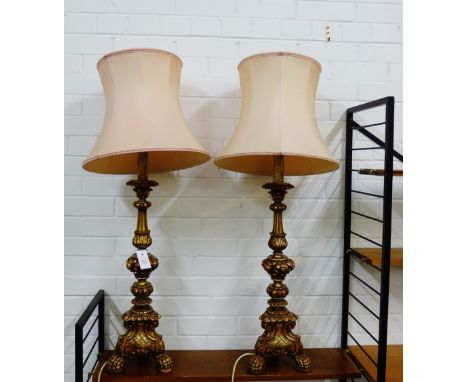 A pair of faux gilt wood knop stemmed table lamp bases on paw feet, complete with shades, 73cm high excluding fittings, (2) 