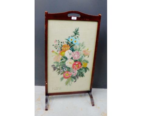 A fire screen with an inset embroidered floral panel