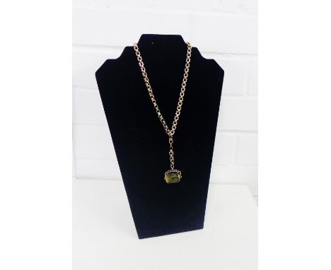9 carat gold framed revolving citrine fob, hung on a gold chain stamped 9ct with two rolled gold clasp fittings 
