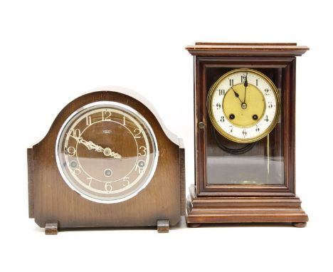 An Edwardian mahogany cased mantel clock, with white enamel dial and brass face with gong strike movement and visual pendulum