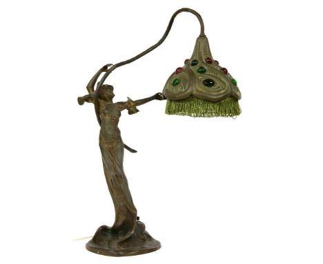 An Art Nouveau spelter figural lamp, with red and green coloured decorative stones set within shade, with green fringe