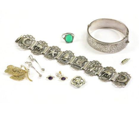 A collection of silver jewellery, to include a flat section hollow single hinge bangle with engraved decoration, a panelled b