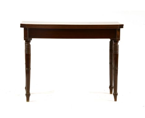 A 19th century mahogany fold over card table, the shaped top over a plain frieze on turned circular legs, 100cm wide, 50cm de