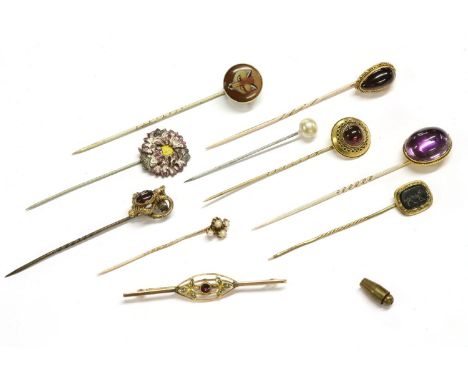 A collection of assorted stick pins, to include a gold foiled back amethyst cabochon example (tested as approximately 15ct go