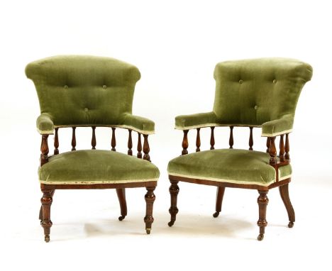 A pair of early 20th century mahogany framed armchairs, with button backs and velour upholstery