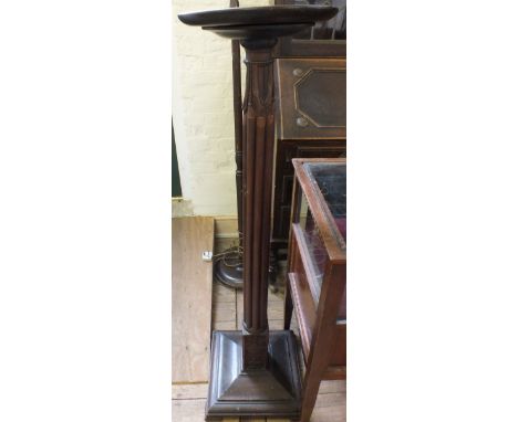 A carved Mahogany torchere and a standard lamp 