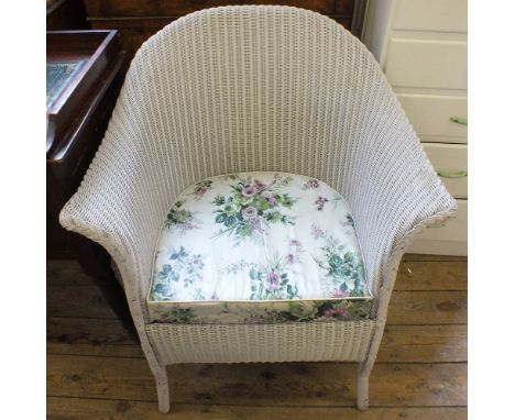 A pair of white painted narrow chest of eight drawers and a Lloyd Loom commode chair