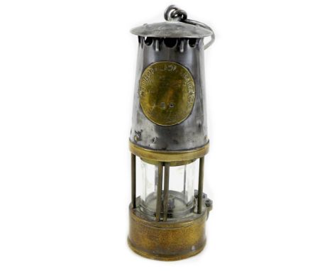 A Victorian steel and brass miner's lamp, brass plaque stamped ?The Protector Lamp & Lighting Co Ltd, Makers & Owners, Eccles