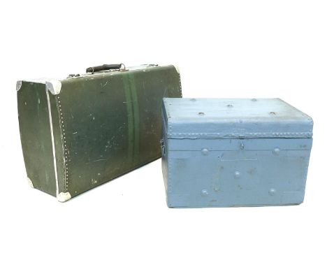 A vintage wooden box trunk with metal edges, studs and pins, later painted blue, with original papered interior and label for