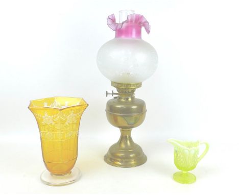 An early 20th century oil lamp, with associated chimney, 19 by 51cm high, together with a Victorian  amber glass celery vase 