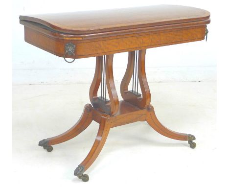 A George IV mahogany, crossbanded and ebony line inlaid card table, the fold over surface inset with green baize, raised on l