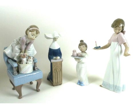 A group of two Lladro and two Nao figurines comprising Lladro: 'Purr-fect Friends', number 6512, 23.5cm high, 'Meditation in 