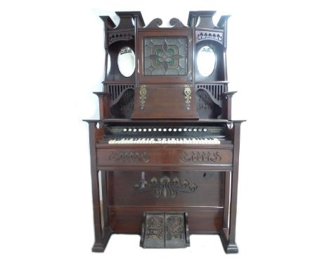 A late 19th century Canadian Clarabella harmonium, with mahogany case, a square form stained glass middle section flanked by 