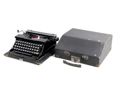 A vintage Blue Bird typewriter, with black finish, serial 302730, in black carry case. 