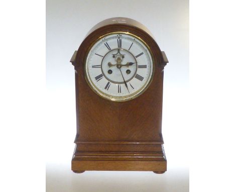 Oak arch top mantel clock with visible brocet escapement and enamel dial