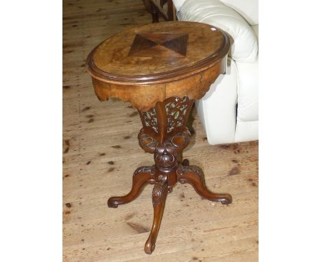 Victorian walnut and satinwood inlaid oval sewing table on carved pedestal to four carved scrolled legs